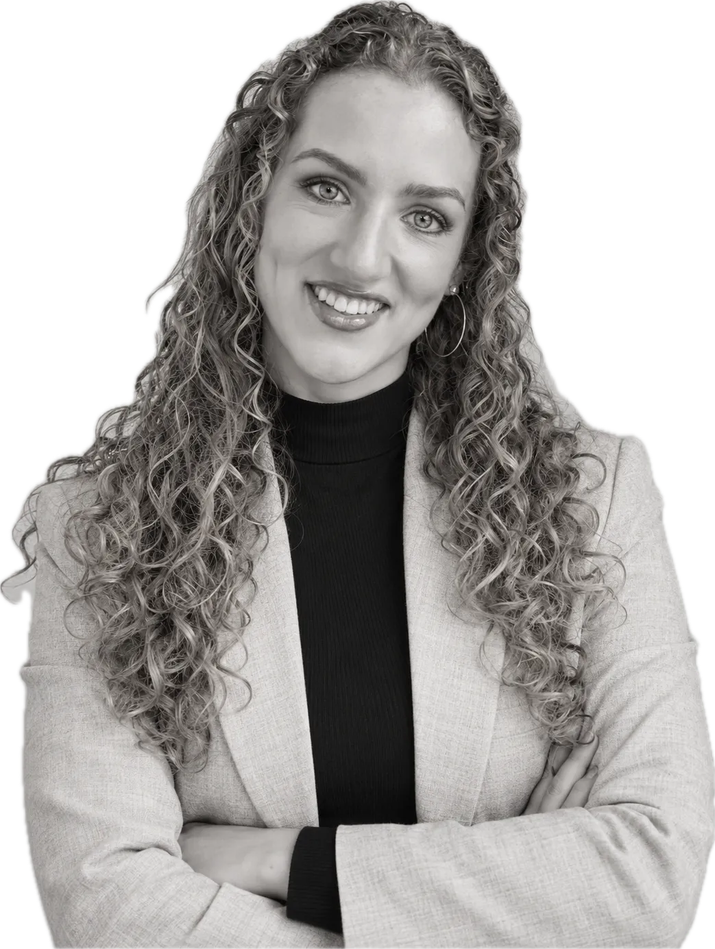 Lily Bell Macdonald smiling, arms folded, in a light blazer and black roll-neck